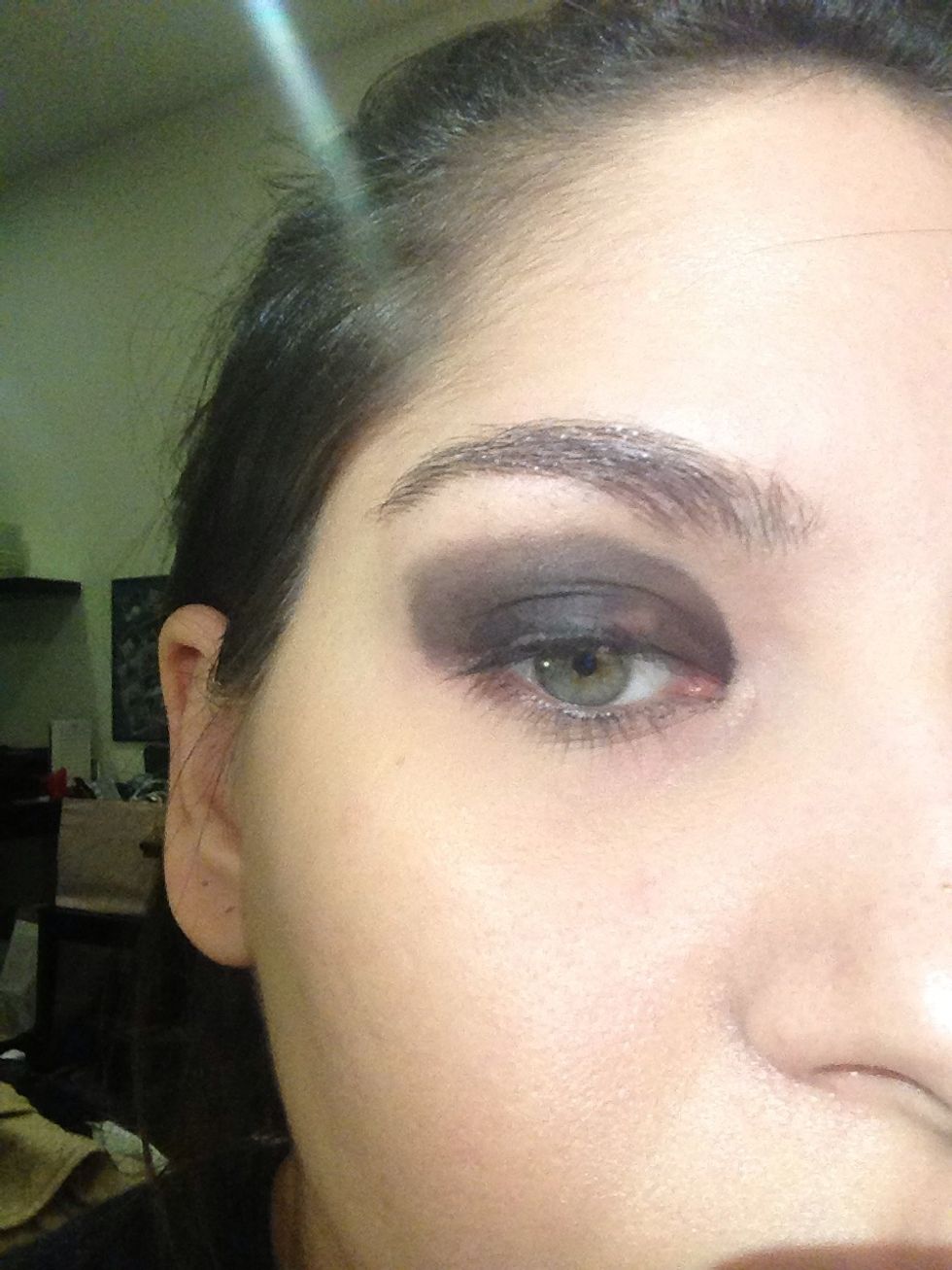 Smudge and blend the eyeliner with a blending brush or a cotton bud