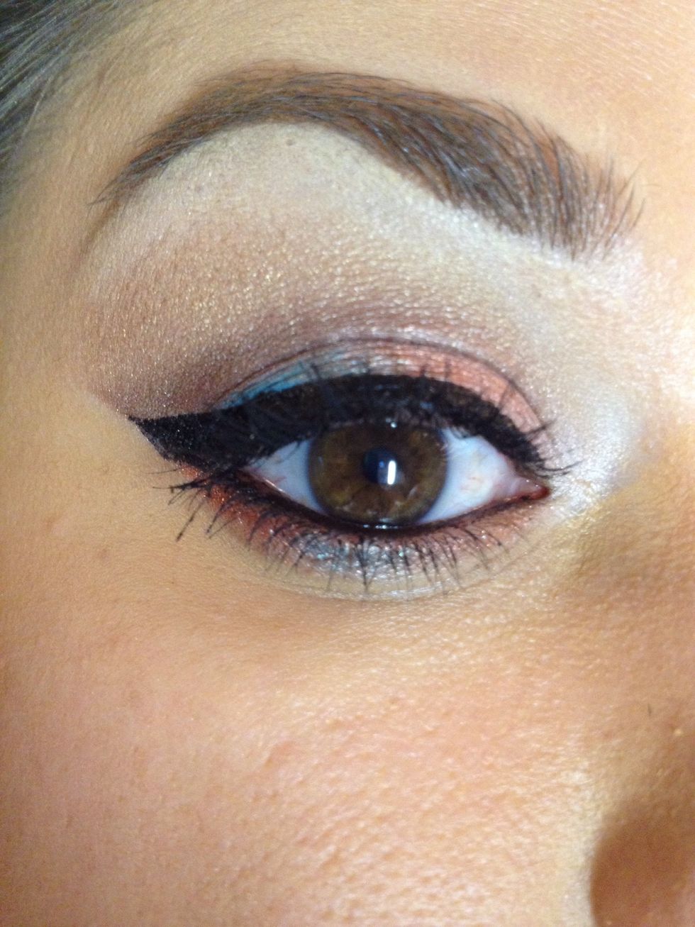 Smudge rust and real along lower lash line and apply black to waterline.