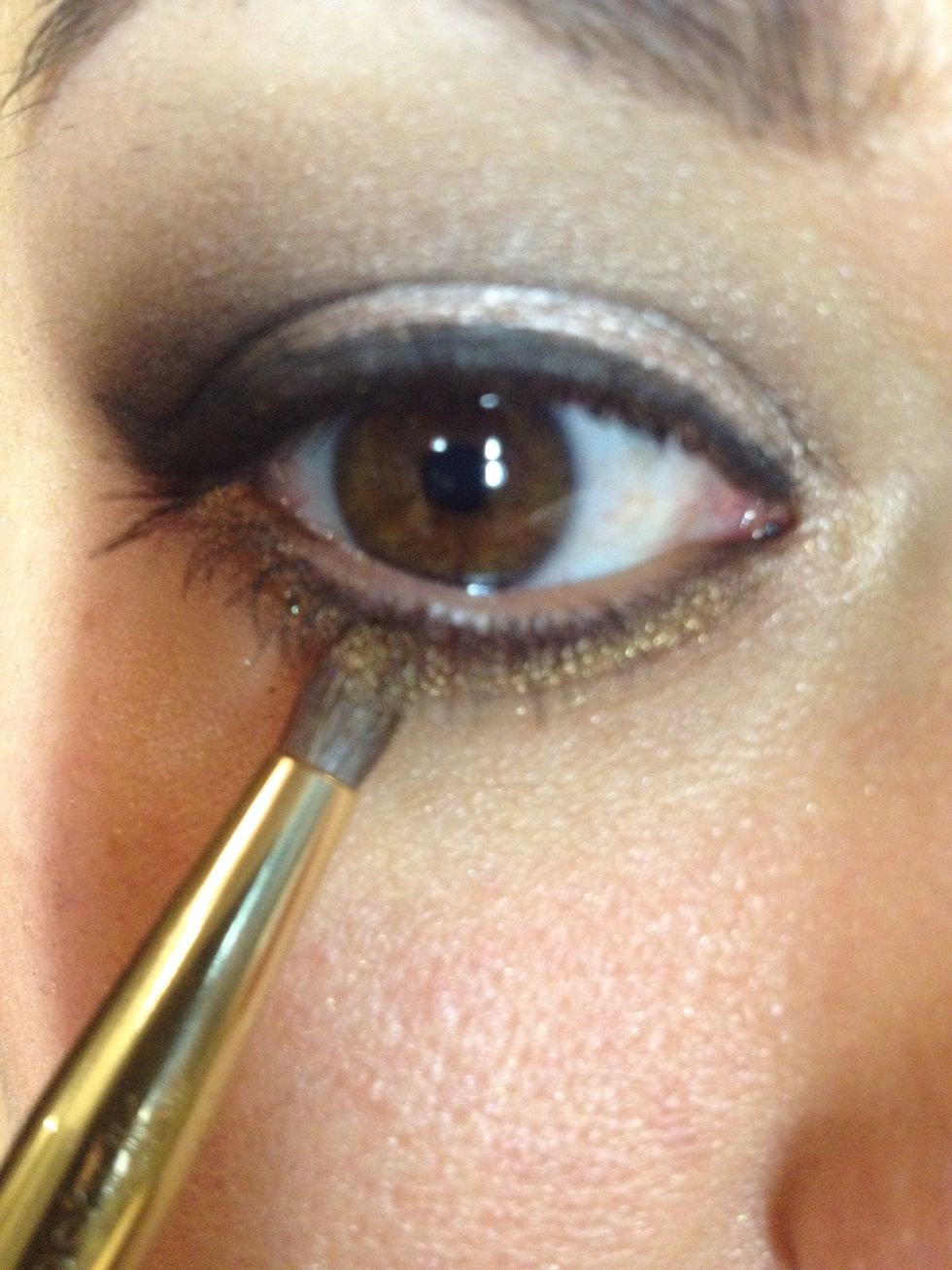 Smudge the deep colors across the lower lash line