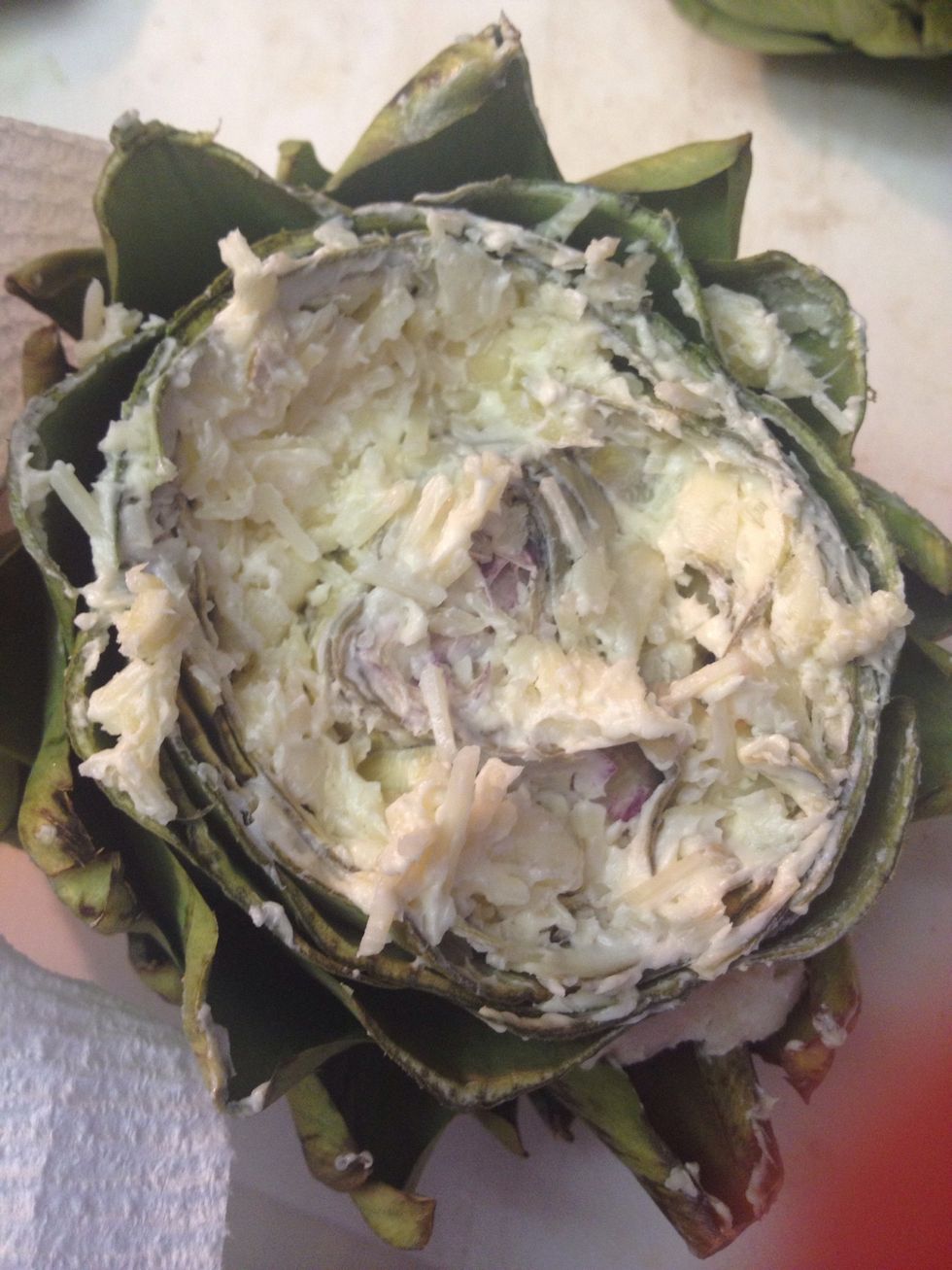 Smush the mixture into the grooves of the artichoke.