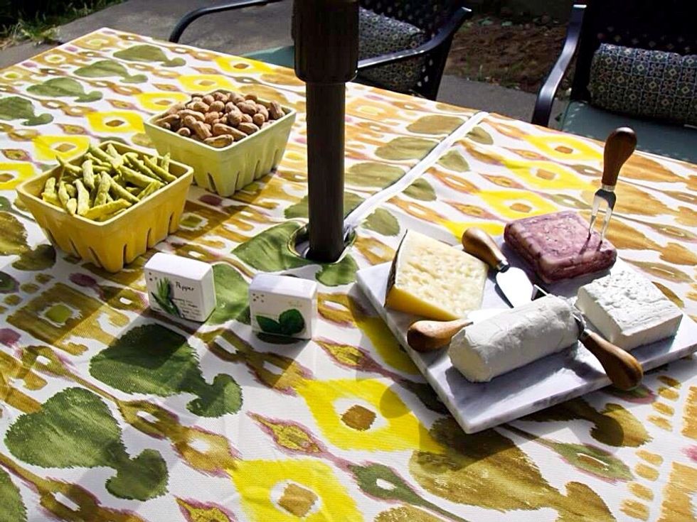 Snacks and cheese plate are served on a table we sit not to get up for every bite
