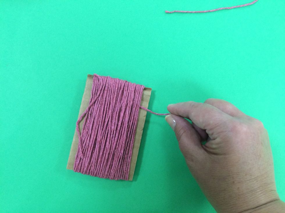 Sneak the piece of yarn under the front section of yarns.