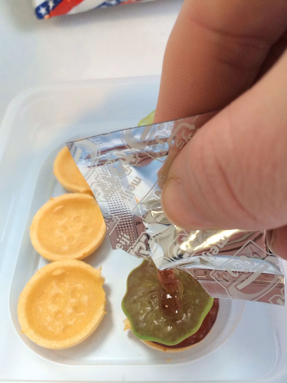 Snip end of SILVER Packet open---Drizzle Burgers with Yummy Strawberry Sauce