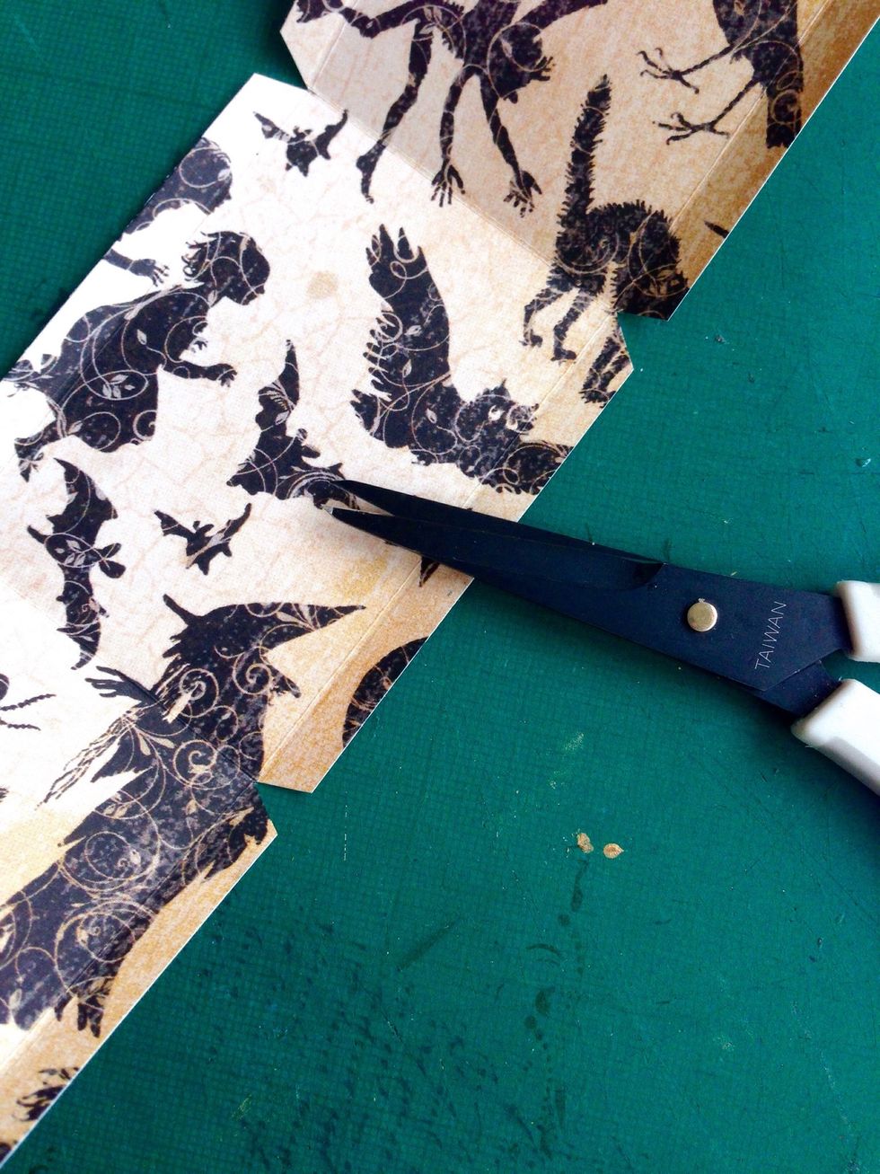 Snip in between the scored marks as shown... This is for easy assembly...