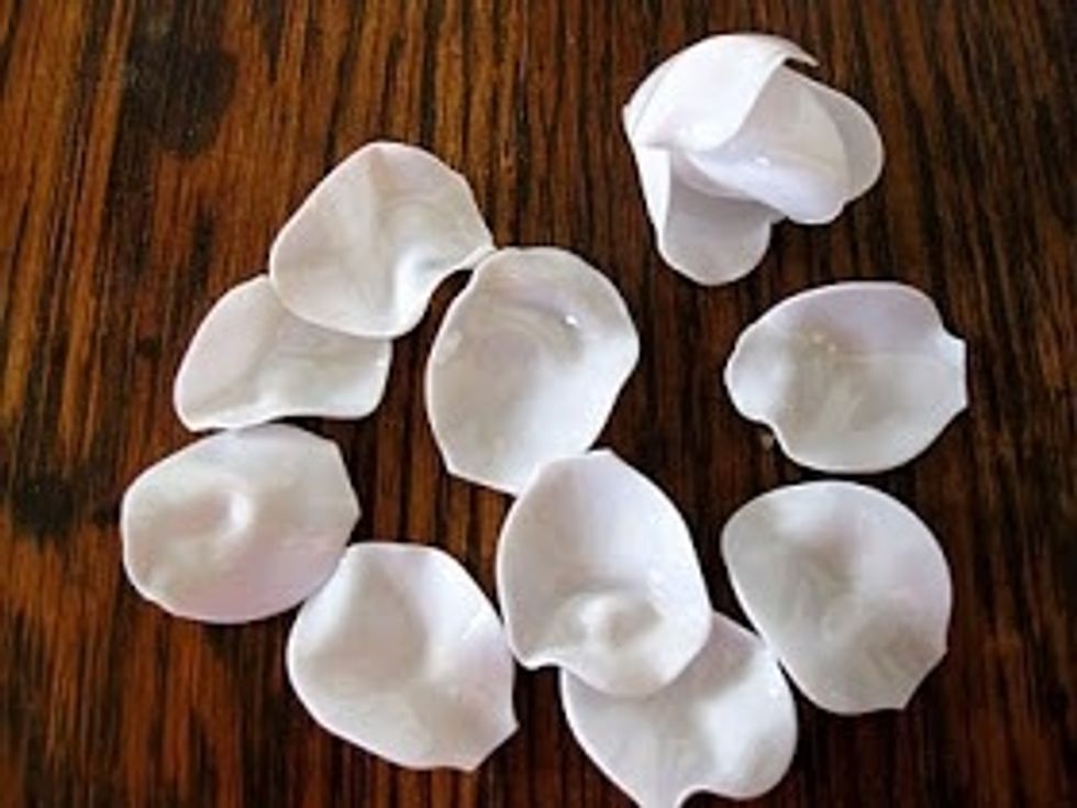 Snip off the handles with garden clippers. When you have about a dozen petals, begin to assemble the rose.