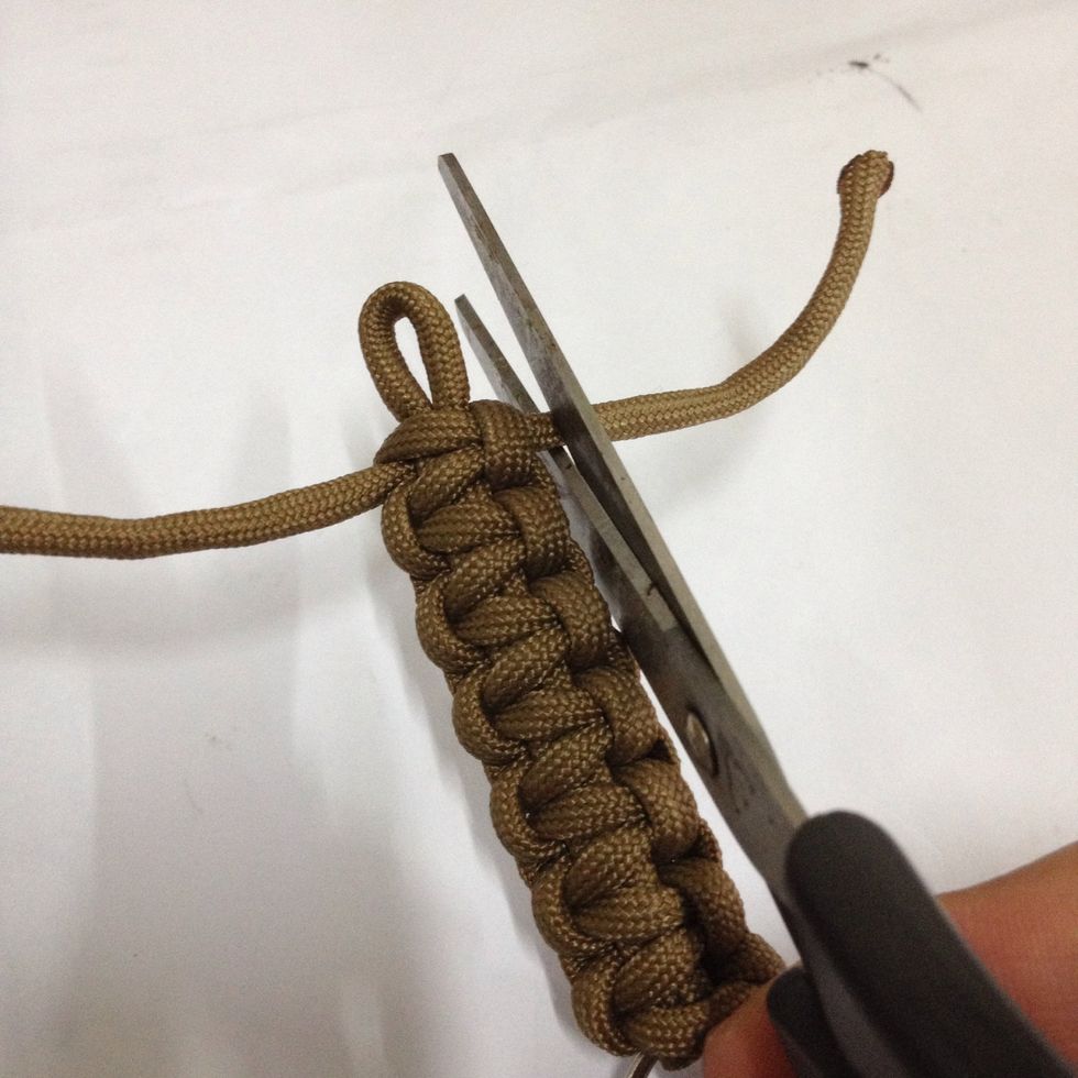 Snip off the remaining cord with your scissors. Leave some length as we need to seal it with a lighter from coming off.