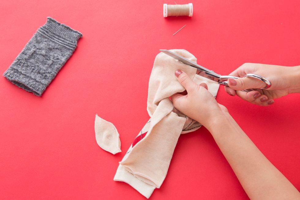 Snip off the tip of the toe so that it is even with the top end of the sock.