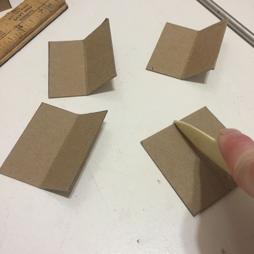 Snip out all 4 corners, and then score them in the middle, set aside