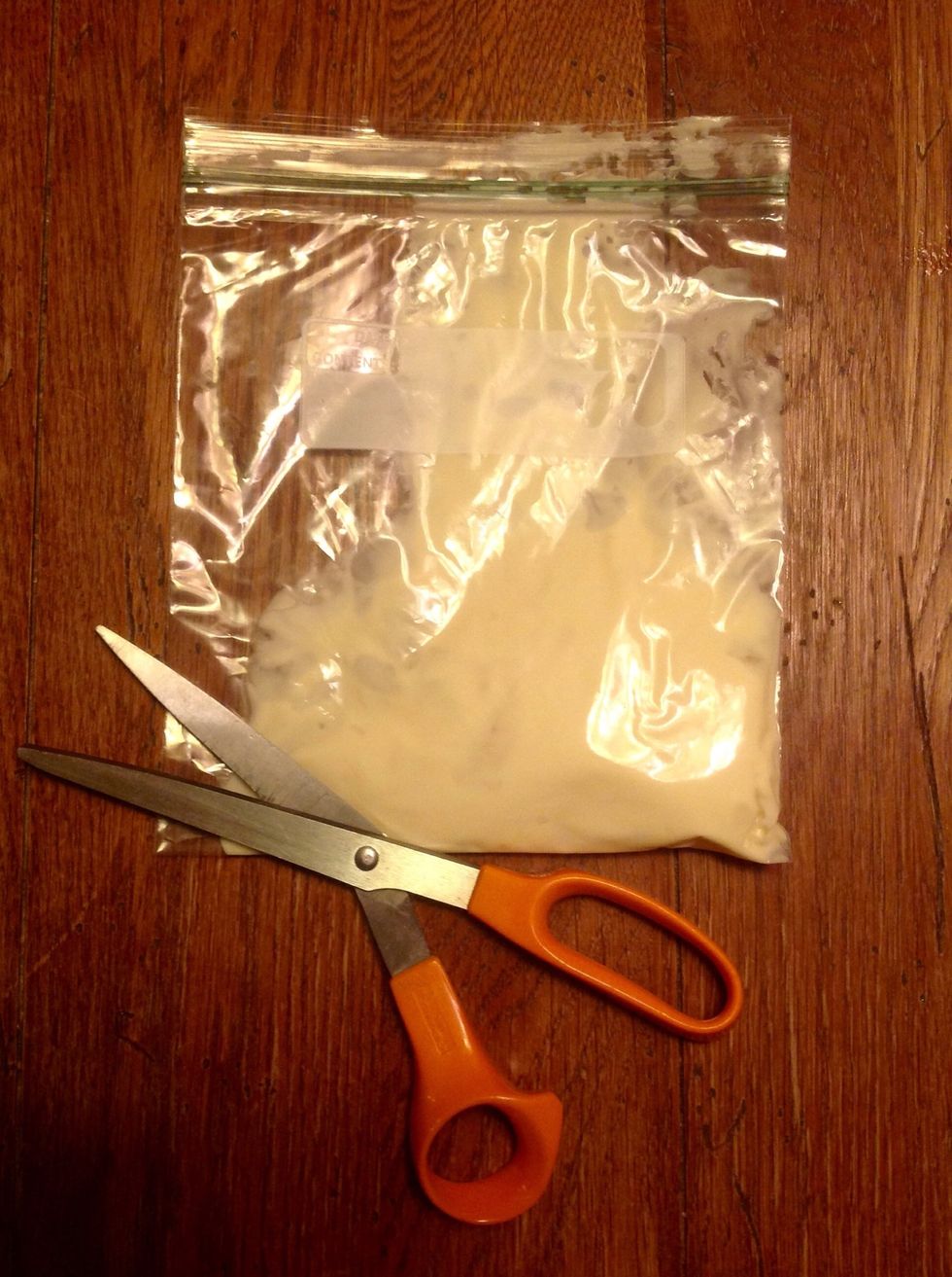 Snip small corner off of Ziplock bag.