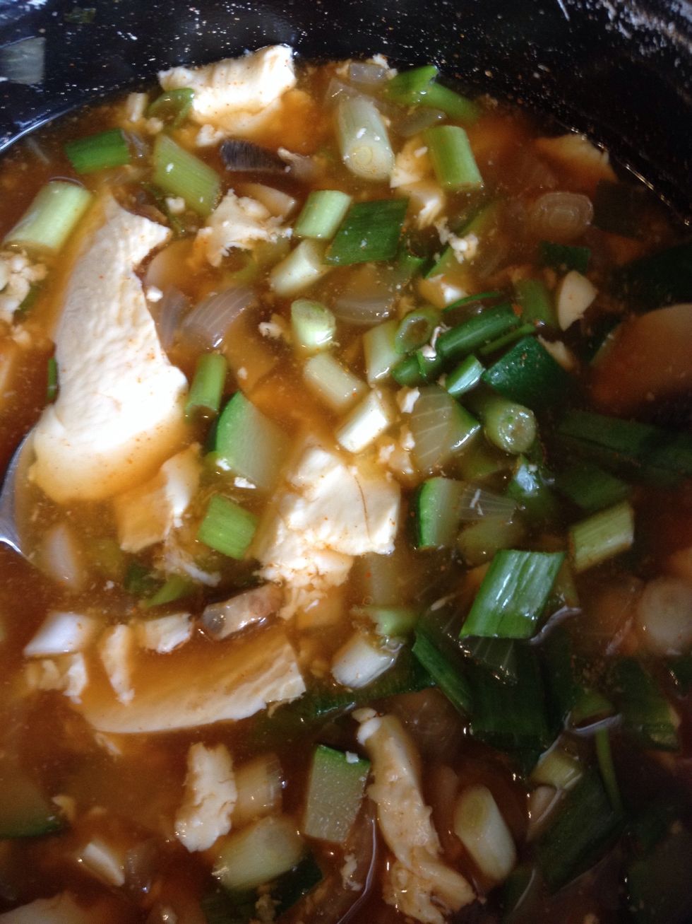 So add in the soft tofu and green scallion. Boil in medium to high heat for about 4-5 minutes until the tofus rise up