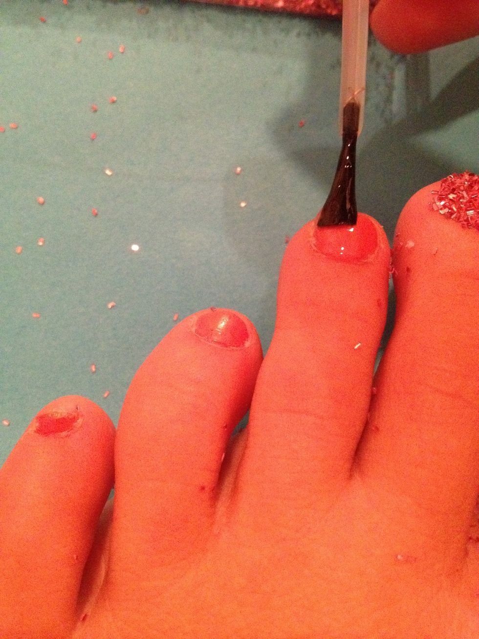 So, add the base coat, or paint your nails the color you picked.
