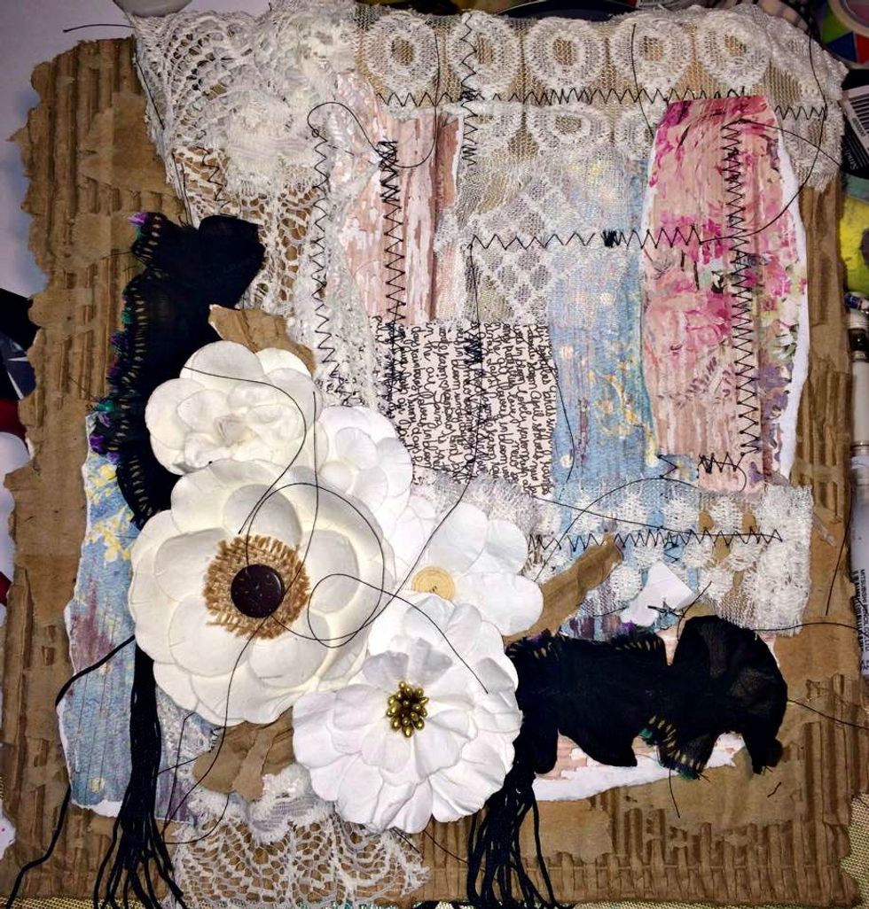 So at this point I've got my elements sewn on and now I'm just playing with placement of the flowers and that fabric that I gathered before. Just trying to see how everything will best fit together