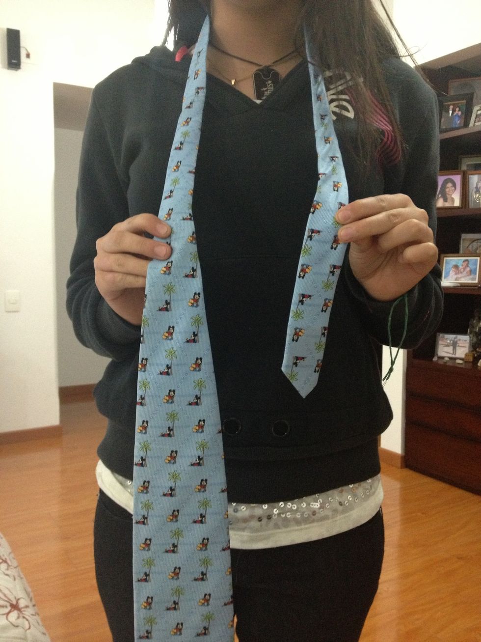 So First you put the tie around your neck una way that the fatest side is at you right and is longer than the thinner side