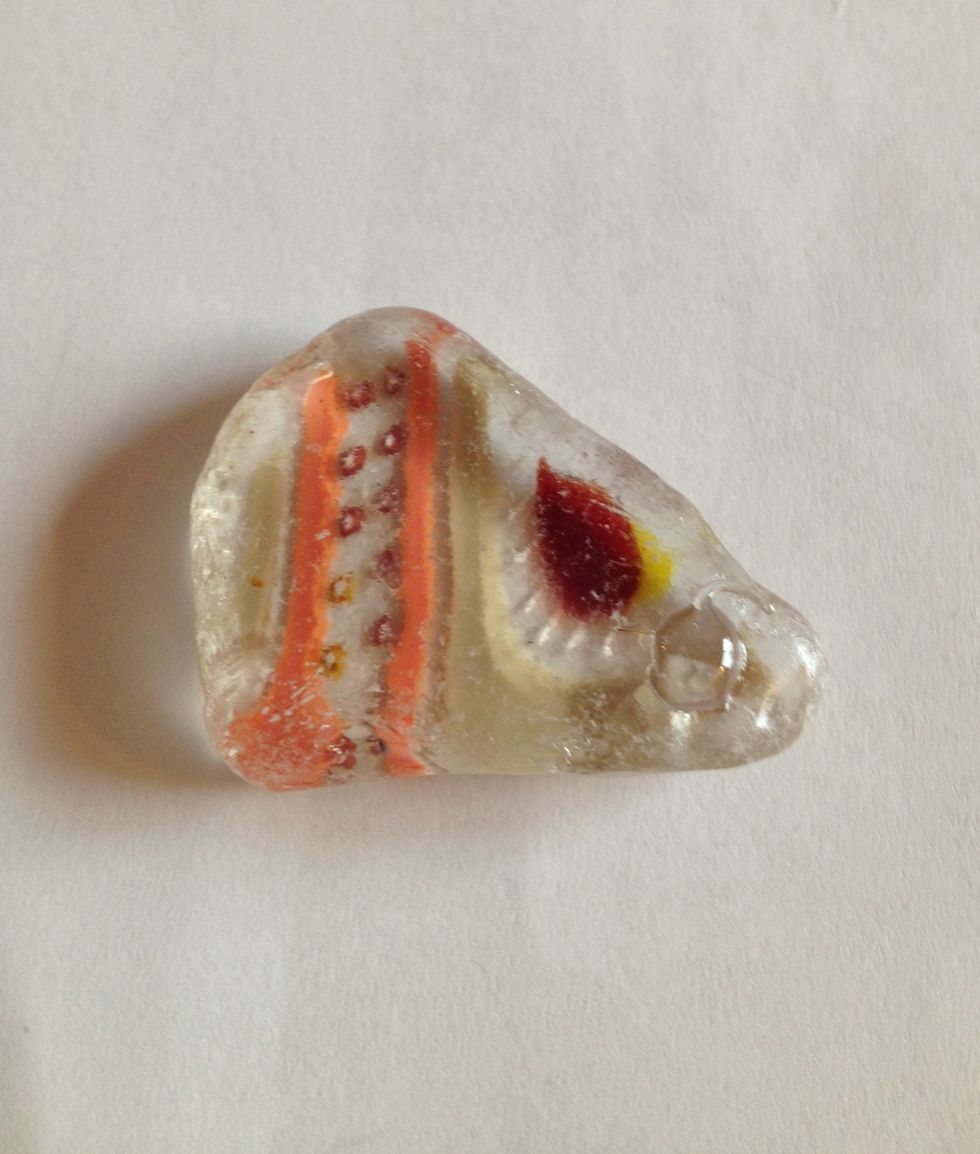 So here's an example - I actually found this piece of glass just like this, with all kinds of colors already in it. Put a dot of glue where you want to put the bail.