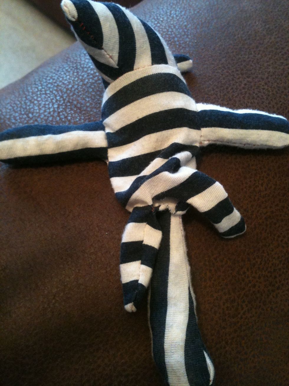 So it should now be completely sewn together apart from the small gap between its legs. Using this gap you stuff it's legs and the rest of its body.