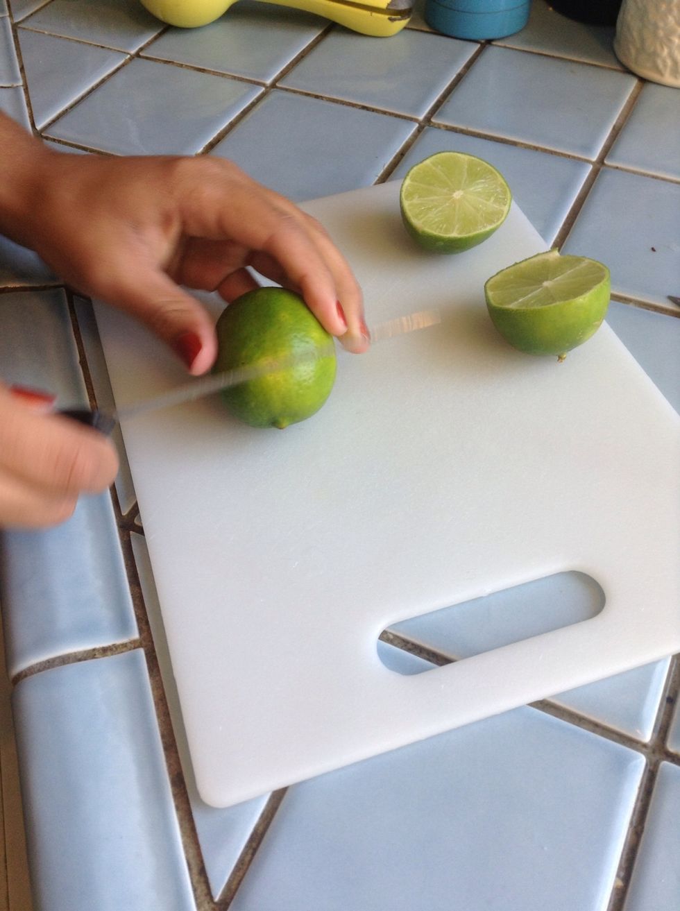So let us begin. My daughter will demonstrate having been recently in Cuba where she practiced under the guidance of her aunt. Cut limes in half. We'll be using the juice of 1 lime per drink.