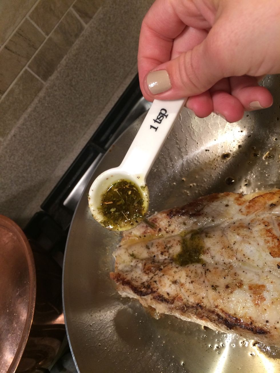 So now that both sides were seared for 4 minutes each I let it rest for about 5 minutes. Then I drizzled the olive oil/garlic/dried spices all over the top. Splash some white wine in the pan too.