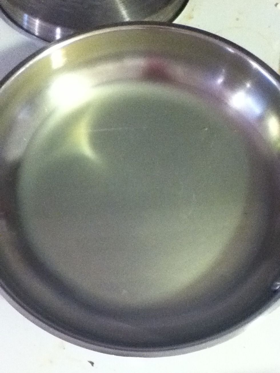 So now you got noodles and you got cheese. Squirt some of that pasta water into your pan and set it on medium high. Maybe a quarter inch of liquid in the bottom?