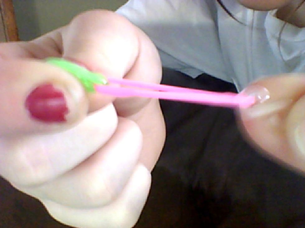 so now you grab 1 more band and fold it inside the other 1 continue this until you reach your finger size.