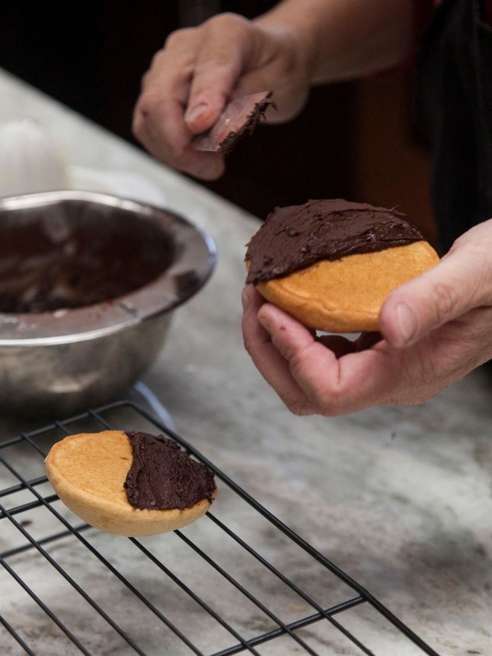 So, now you have two bowls of icing, one chocolate, one vanilla. Turn the cookies flat side up, and frost what used to be the bottom.