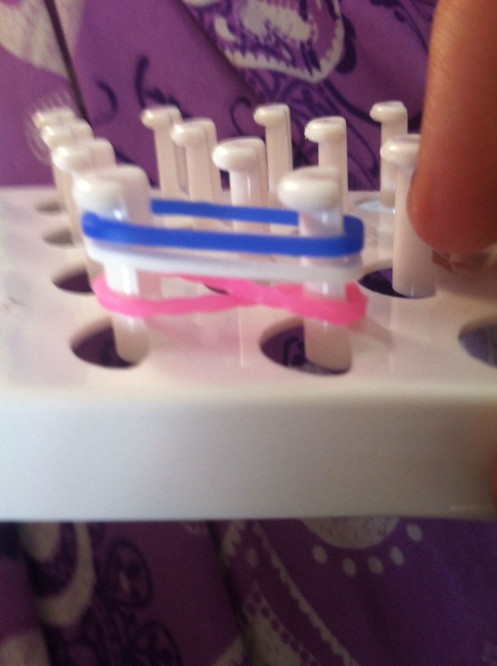 So wat u wanna do is twist the rubber band into a infinity sigh then add on two rubber bands.