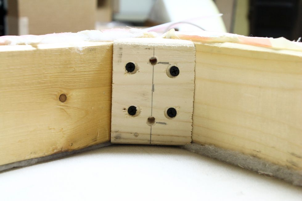 So we made a wedge for the inside corners of the riser to attach the legs in the corners since I didn't want them facing to the front or sides. We predrilled 2 holes in the wedge for the leg screws.