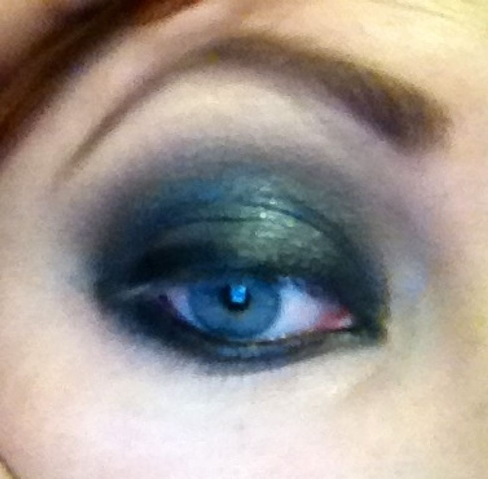 So what you can see here I've blended into the brow Bone removing harsh lines and I've added a touch of midnight blue to the centre. If you look along top lash you'll see I've added a rough dark line