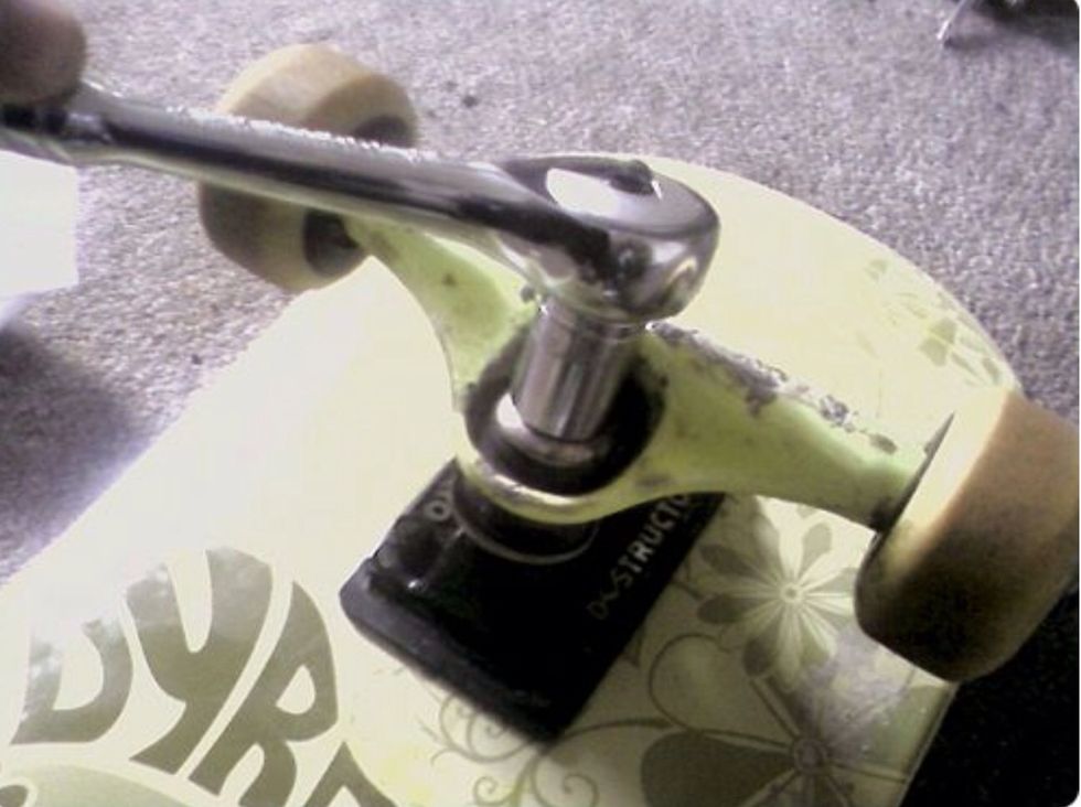 So your skateboard is all back together. Time to readjust your trucks' King pin. This is the mega-screw in the middle of your trucks. It adjusts how stiff or loose your turning is.