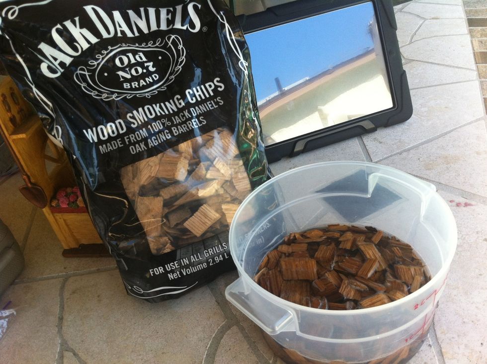 Soak a couple cups of wood chips in water for about an hour. I use jack daniels wood chips just because im a whiskey drinker and these chips literally smell like a glass of JD.. Good stuff!