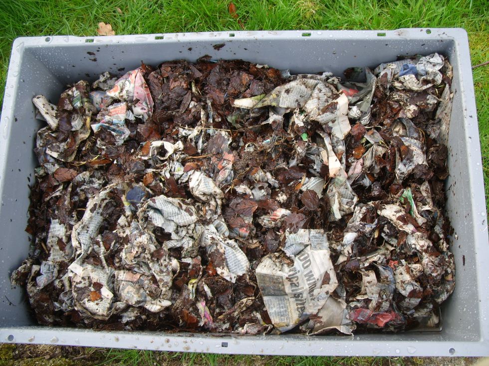 Soak a mixture of shredded newspaper/cardboard/leaves/straw/sawdust/compost in a bucket or wheelbarrow. Add it to the upper tray - the excess moisture will drain down into the moisture catching tray.