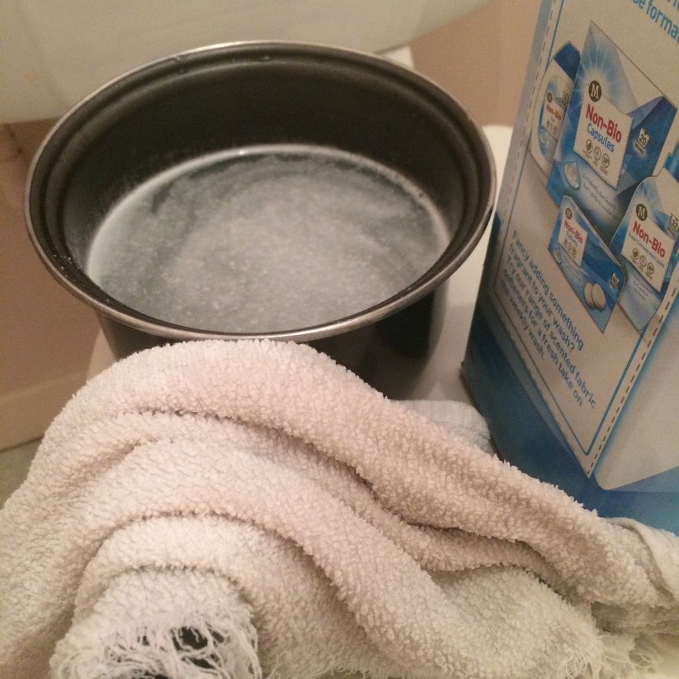 Soak a tip of the rag into the soapy water