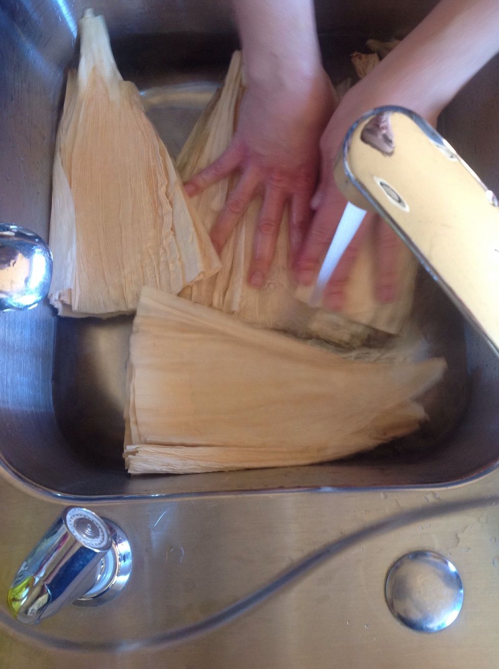Soak corn husks in warm water. Immerse to soften.