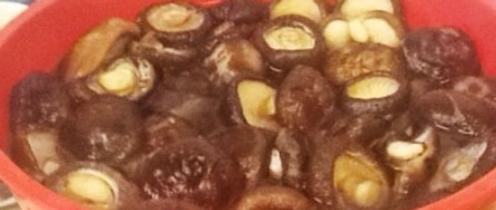 Soak dried shiitakes in warm water for an hour or two. Leave them whole, but pinch off the tough stems.