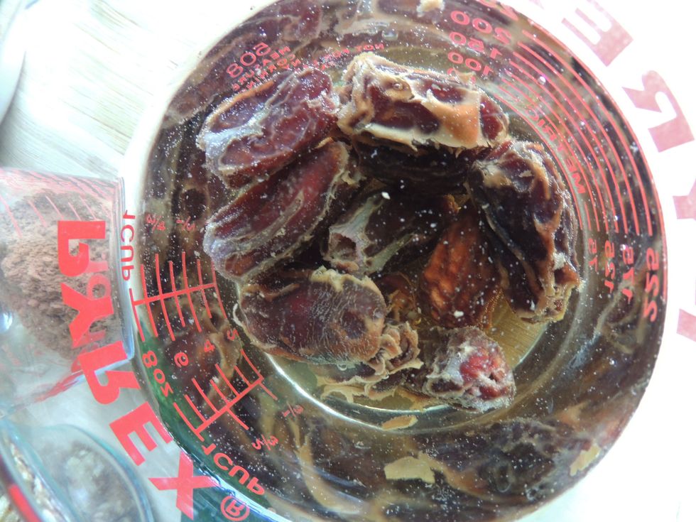 Soak the dates at least half an hour. Add them and the walnuts to food processor or blender. Should be a crumbly mix. Press this mixture into the bottom of a greased 8x8 pan. Pour the batter on top.