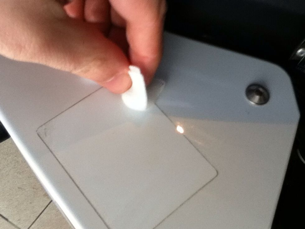 Soak the gauze in the benzene and start applying it to the glue residue.