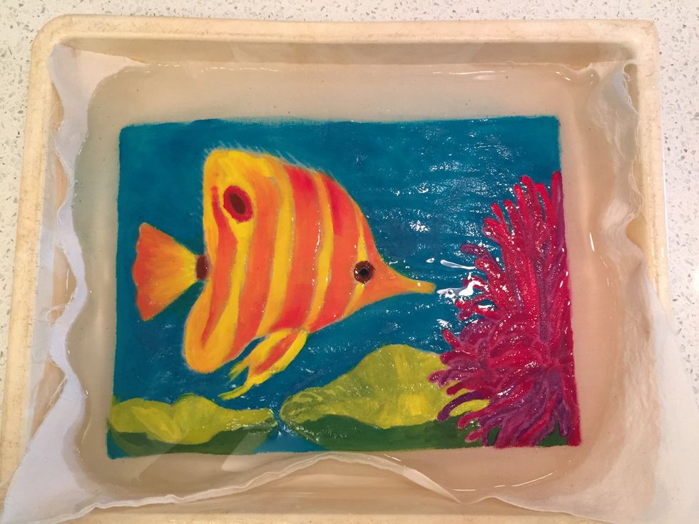 Soak the painting in a tray of warm water.