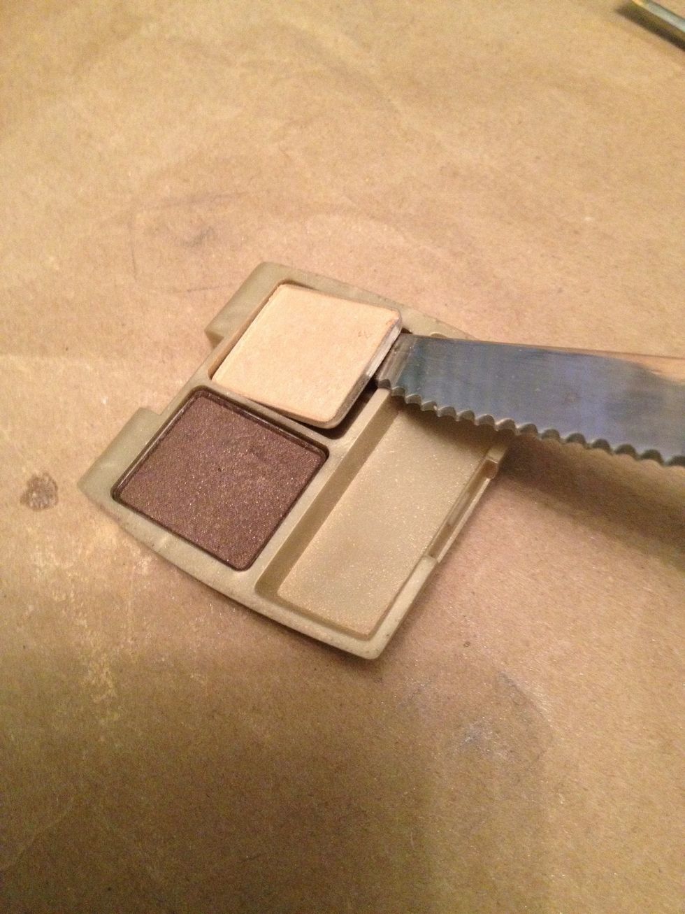 Some eyeshadows can easily be pulled out using tweezers or a kitchen knife.  Stick blade between metal and plastic and apply pressure.