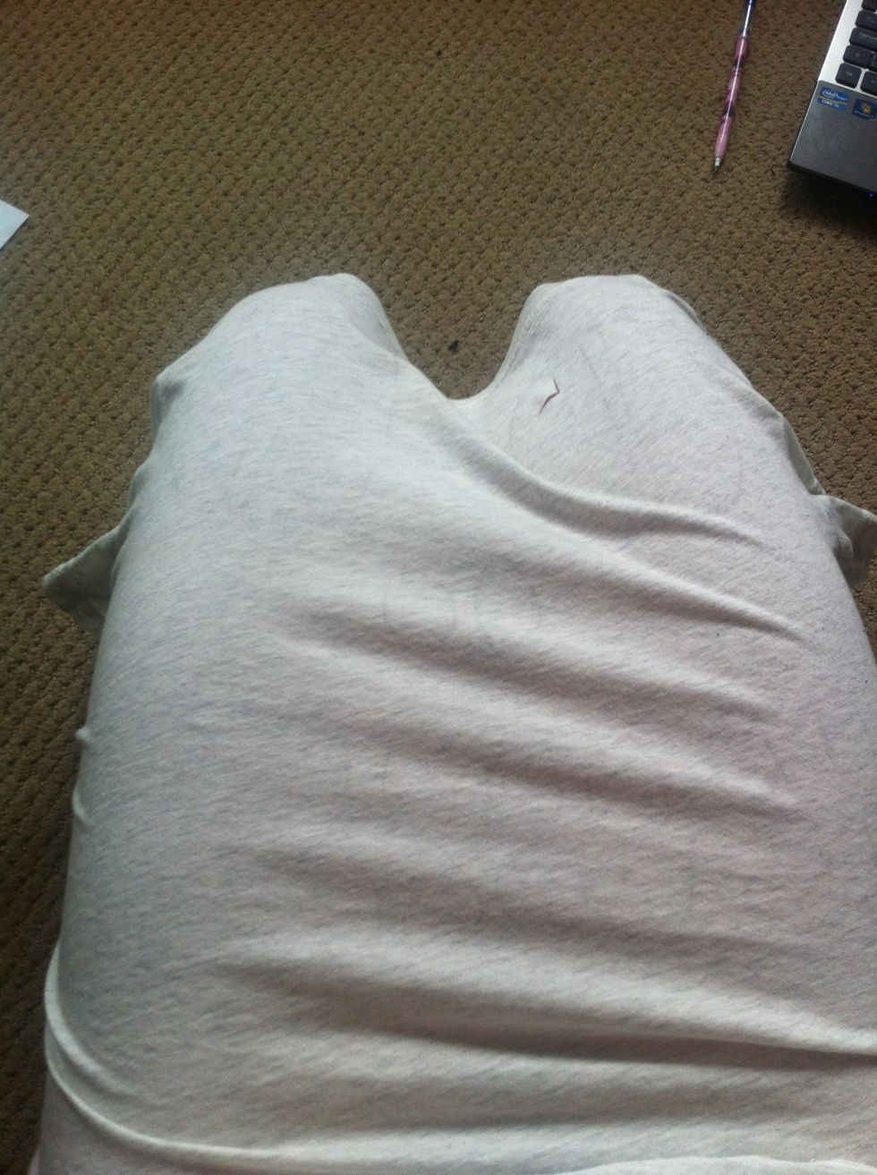 Some people put an open box in their shirt to cut, I put it over my knees. Just be careful not to cut yourself. Or your pants.