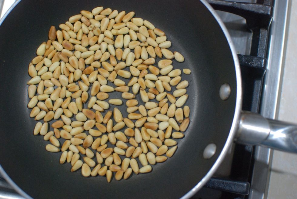 Some recipes do not call for toasting nuts but the nutty flavor of toasted pine nuts contribute well to a pesto recipe. Toast until somewhat golden brown.