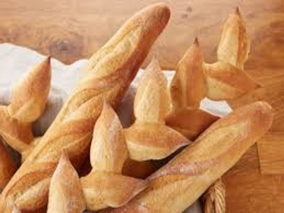 Some variations of french dough - A baguette on the left and a traditional French "Epi" (pull-apart rolls) on right. Epi are formed like baguettes, but cut and twisted to resemble the wheat stalk.