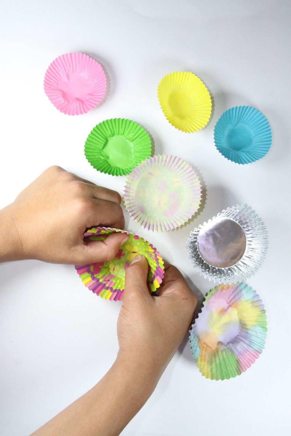 Something I just discovered, push the bottom of the cupcake holder to turn it inside out. That way the colorful side shows more. I put it inside of another holder and alternated large and small ones.