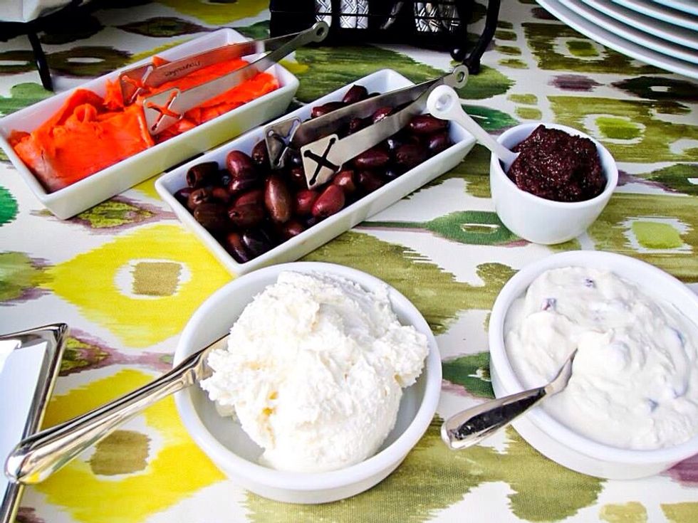 Something to top the bagels or crackers: smocked salmon, cream cheese, sweet soft cheese with raisins, olives and such