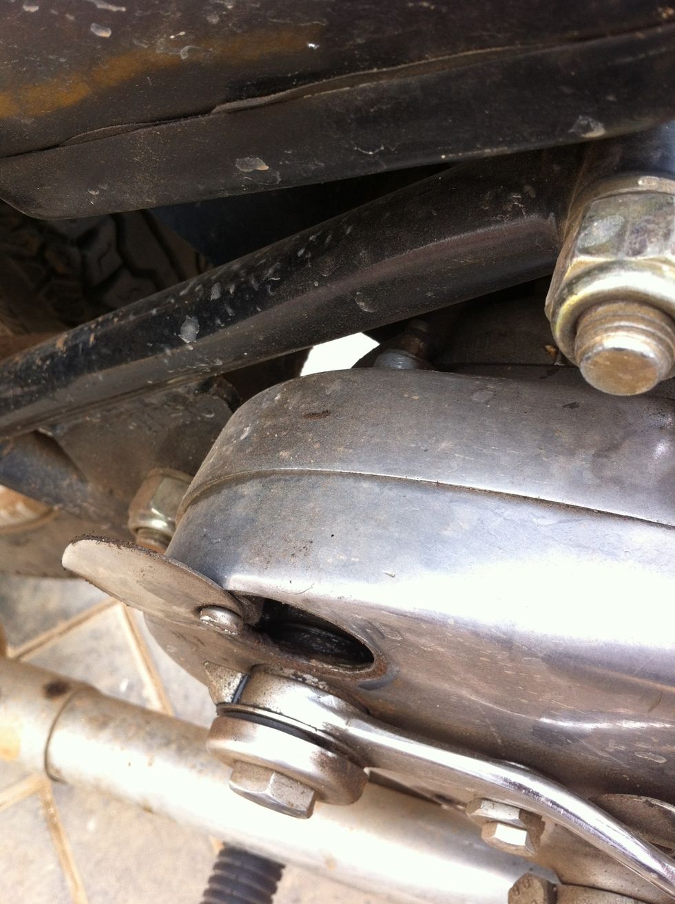 Sometimes the cable end can get so seated in that you may need to use a screwdriver to push it out from inside the gearbox through the access hole