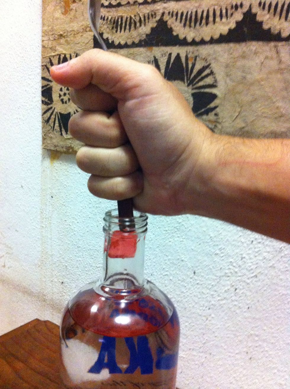 Sometimes the Jolly Ranchers candies get sticky and stuck in the neck of the bottle, I use the reverse of a spoon to with delicacy push them inside.