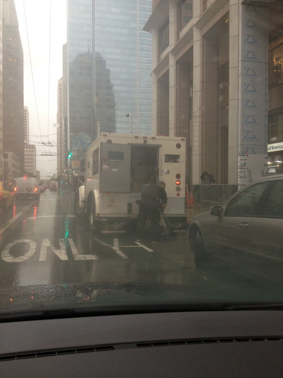 Sometimes you find a gem of a spot that you can wait out if you're patient - in this case some armed guards are in the bank. Boo-ya. Waiting it out. Key: ignore honking motorists not in on your plan.