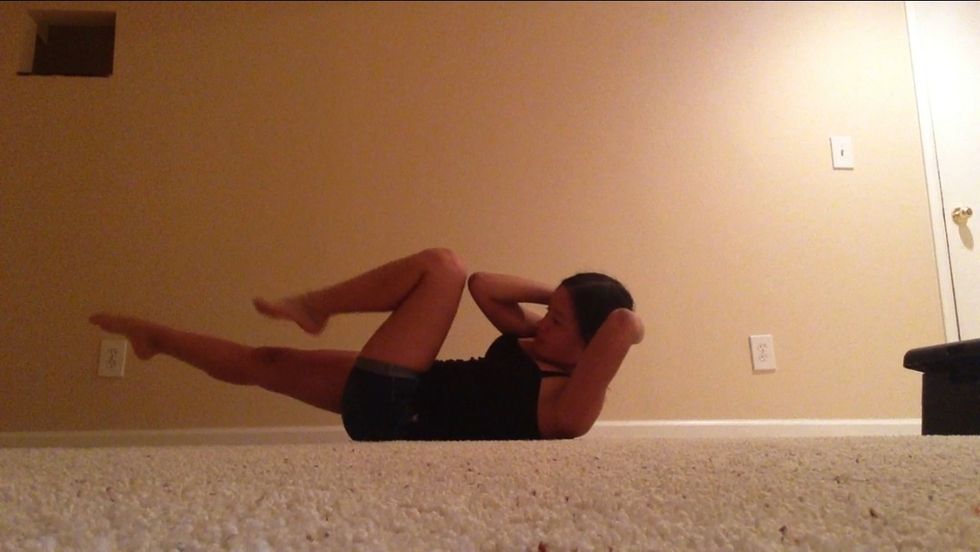 Soon enough do these bicycle touches by getting your elbow touch the opposite knee switch back and forth and do this for about a minute.
