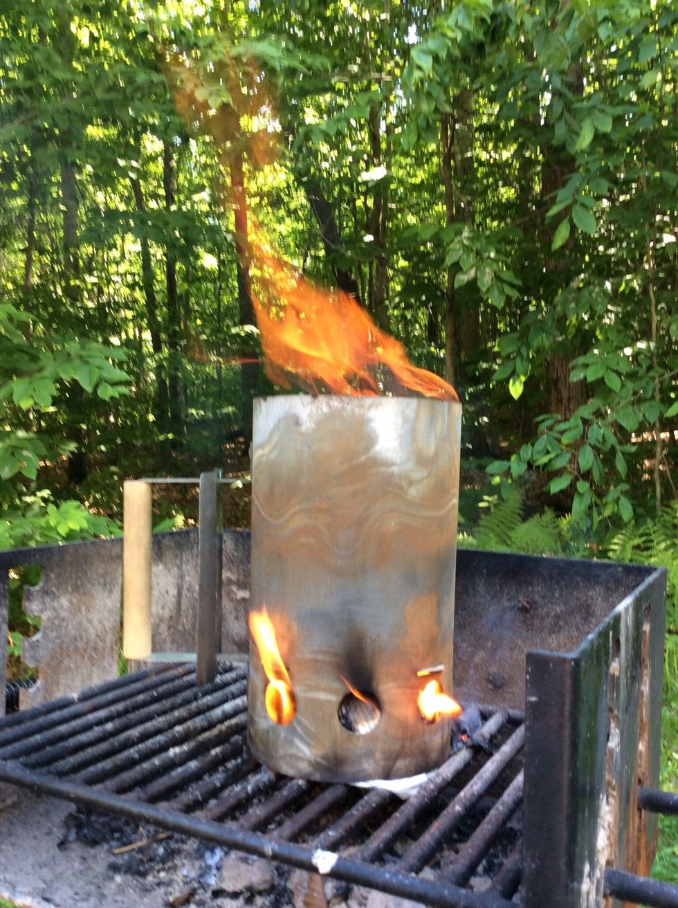 Soon ... when I get flame pouring out of the top of the chimney the coals are almost ready. Newspaper is added and lit under the chimney to get the coals fire hot.