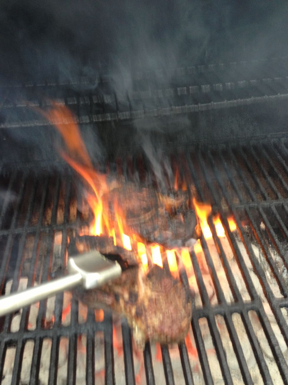 Sorry for the bad pic.. After turning the steaks over, use the left over olive oil to coat the side that was just down. The fire may get very hot here. If so, reduce the cooking time on this side.