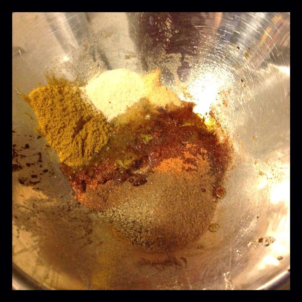 Spices in a bowl. Curry, Kefta, black pepper, creole seasoning, onion powder, garlic powder, olive oil.