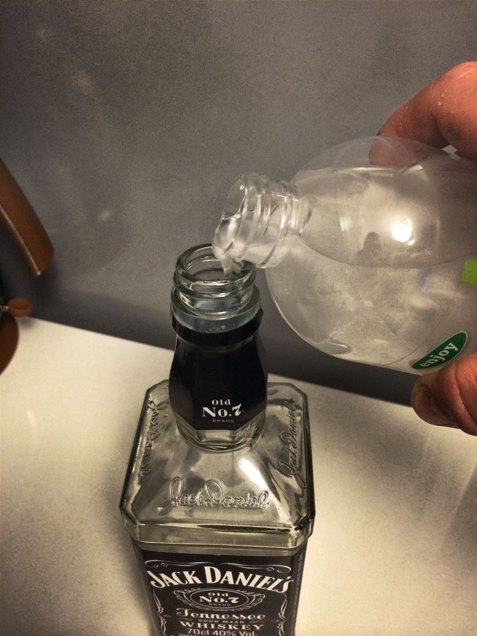 Spill the liquid soap into the empty bottle.